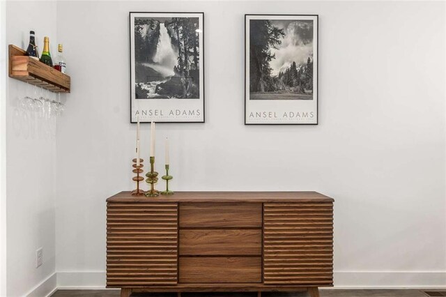 interior details featuring baseboards and wood finished floors