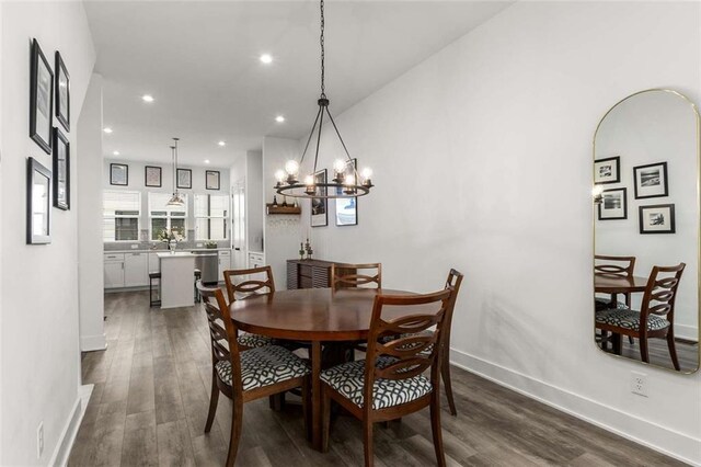 dining area featuring recessed lighting, baseboards, dark wood-style floors, and a notable chandelier
