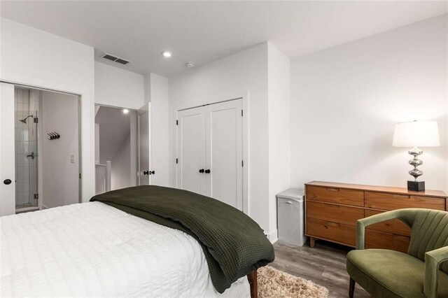 bedroom with recessed lighting, wood finished floors, and visible vents