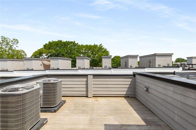 view of patio with central air condition unit and a balcony