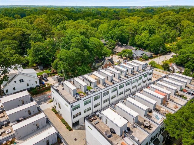birds eye view of property featuring a wooded view