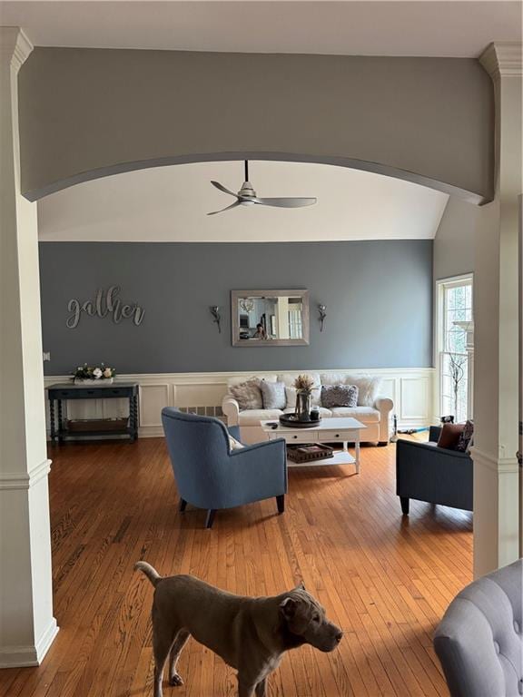 living room featuring ornate columns, wood-type flooring, vaulted ceiling with beams, and ceiling fan