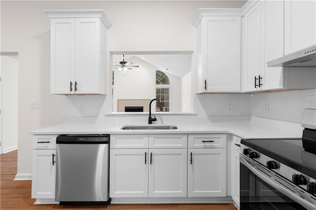 kitchen featuring white cabinets, stainless steel appliances, ceiling fan, and sink