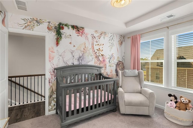 carpeted bedroom with a crib