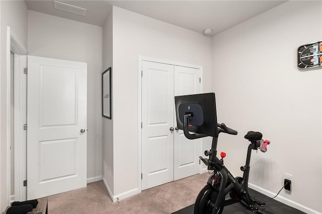 exercise room with light carpet