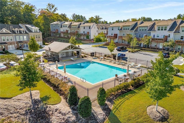 view of pool with a patio and a yard