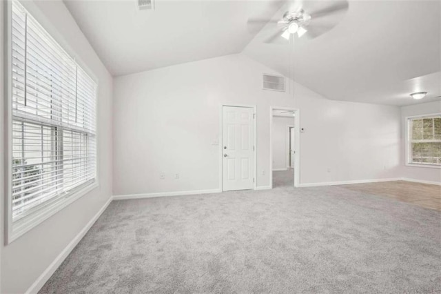 unfurnished room with ceiling fan, carpet floors, and lofted ceiling