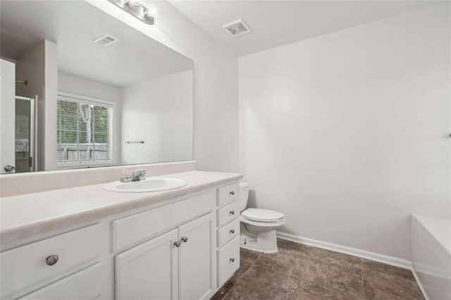 bathroom featuring walk in shower, vanity, and toilet