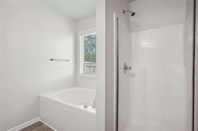 bathroom featuring tile patterned flooring and separate shower and tub