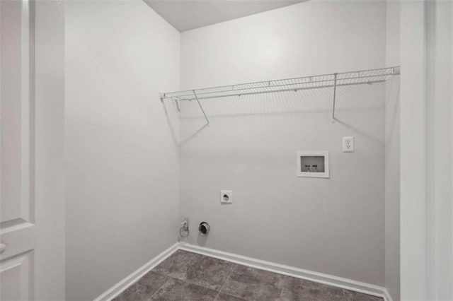 laundry room featuring washer hookup, hookup for an electric dryer, gas dryer hookup, and dark tile patterned flooring