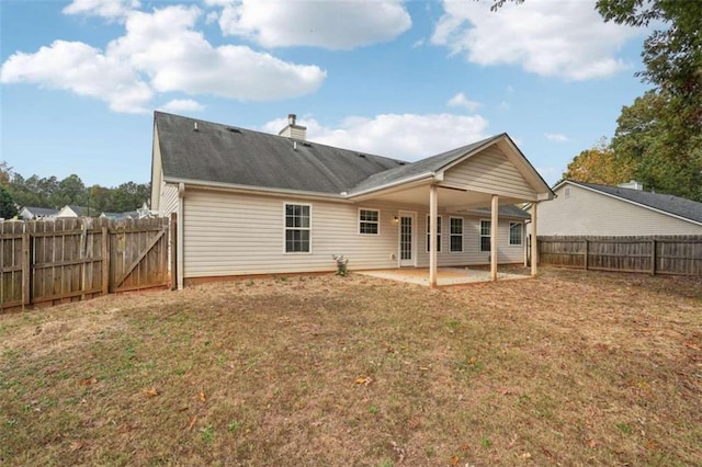 back of property featuring a patio area and a yard