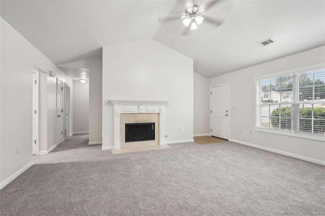 unfurnished living room featuring ceiling fan, lofted ceiling, and light carpet