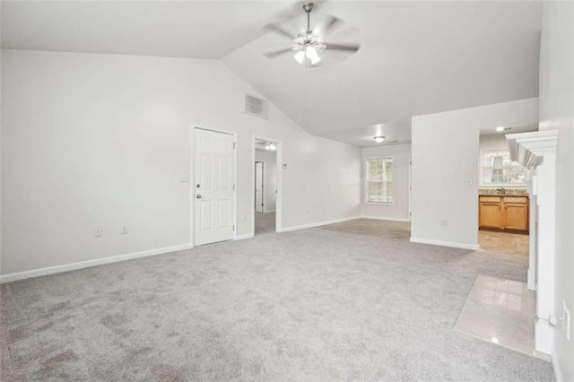 unfurnished living room featuring ceiling fan, light carpet, and vaulted ceiling