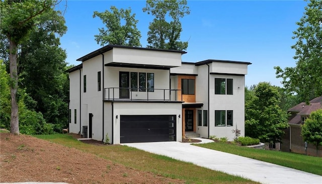 1610 Niskey Lake Rd, Atlanta, GA 30331 - modern home with a balcony, stucco siding, driveway, and an attached garage