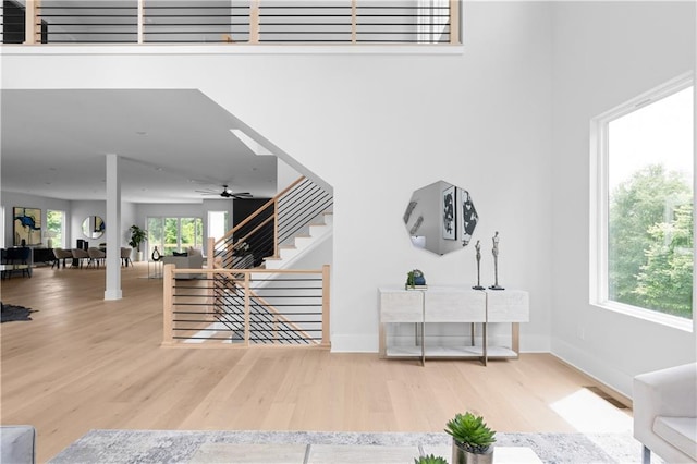 1610 Niskey Lake Rd, Atlanta, GA 30331 - living area featuring wood finished floors, stairway, baseboards, and ceiling fan