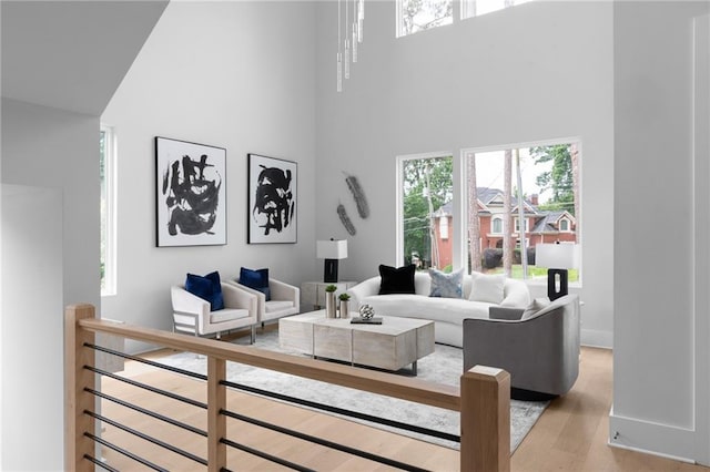 1610 Niskey Lake Rd, Atlanta, GA 30331 - living room featuring a high ceiling, light wood-style flooring, and baseboards