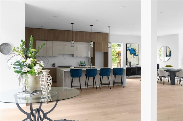1610 Niskey Lake Rd, Atlanta, GA 30331 - kitchen with modern cabinets, light countertops, light wood finished floors, and an island with sink