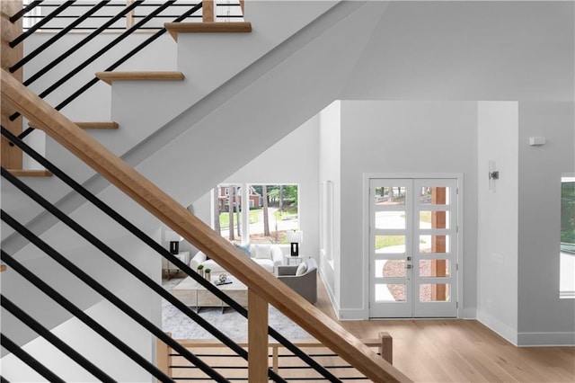 1610 Niskey Lake Rd, Atlanta, GA 30331 - staircase featuring french doors, wood finished floors, and baseboards