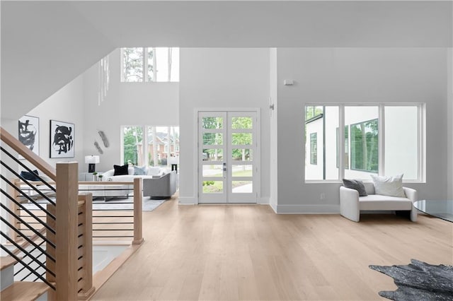 1610 Niskey Lake Rd, Atlanta, GA 30331 - living room with light wood-type flooring, healthy amount of natural light, stairway, a high ceiling, and french doors