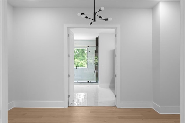 1610 Niskey Lake Rd, Atlanta, GA 30331 - hallway with a chandelier, baseboards, and light wood-style flooring