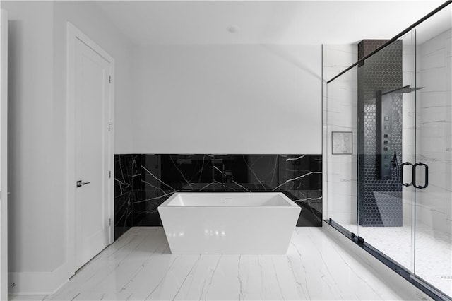 1610 Niskey Lake Rd, Atlanta, GA 30331 - full bathroom featuring a soaking tub, tile walls, a stall shower, marble finish floors, and wainscoting