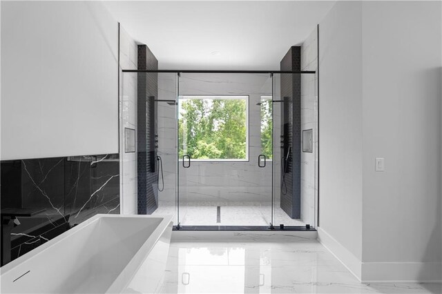 1610 Niskey Lake Rd, Atlanta, GA 30331 - full bathroom with marble tiled flooring, a freestanding bath, a marble finish shower, and baseboards