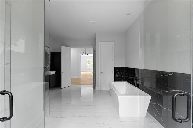 1610 Niskey Lake Rd, Atlanta, GA 30331 - bathroom featuring a freestanding tub, marble finish flooring, and a shower with door