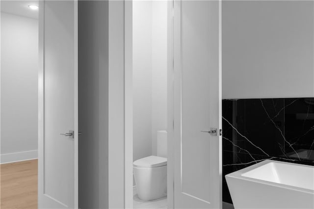 1610 Niskey Lake Rd, Atlanta, GA 30331 - bathroom with toilet, baseboards, and wood finished floors