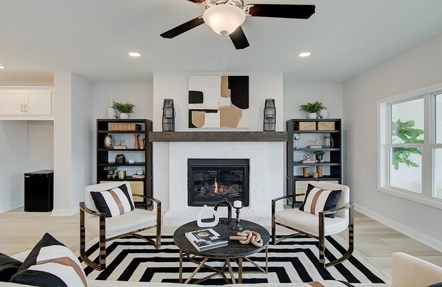 kitchen with pendant lighting, white cabinets, wall chimney range hood, a kitchen island with sink, and stainless steel microwave