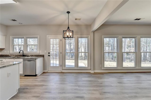 doorway featuring an inviting chandelier, sink, and light wood-type flooring