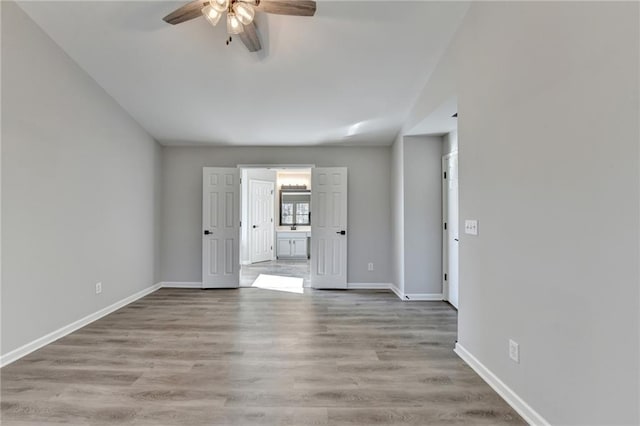 unfurnished room with ceiling fan and light wood-type flooring