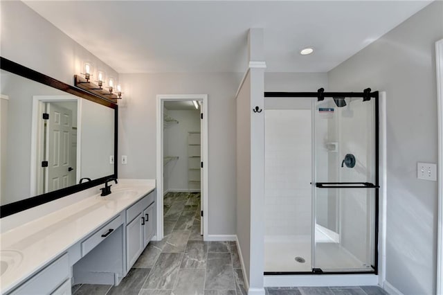 bathroom featuring an enclosed shower and vanity