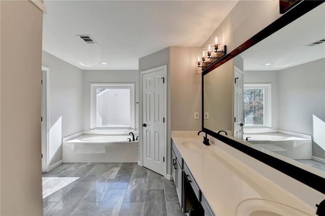 bathroom with a tub to relax in and vanity