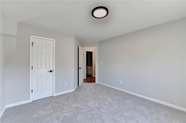 unfurnished bedroom featuring light carpet