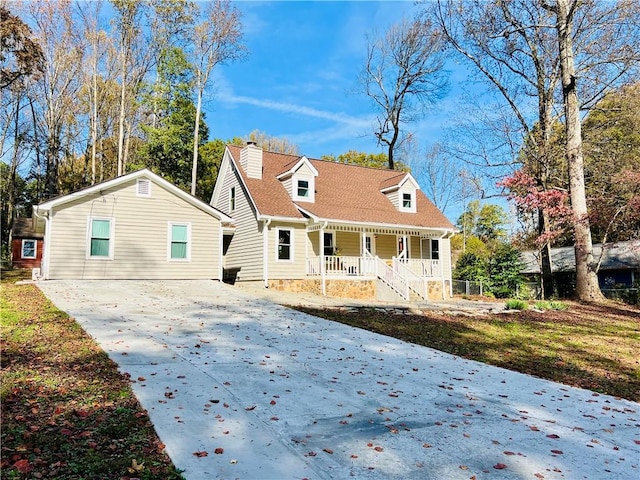 back of house featuring a yard and covered porch