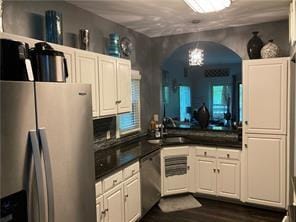 kitchen with stainless steel appliances, sink, a chandelier, dark hardwood / wood-style floors, and white cabinetry