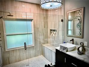 bathroom with vanity and an enclosed shower