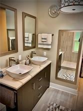 bathroom with vanity and wood-type flooring