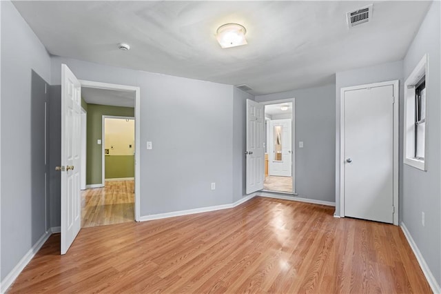 unfurnished bedroom with light wood-type flooring