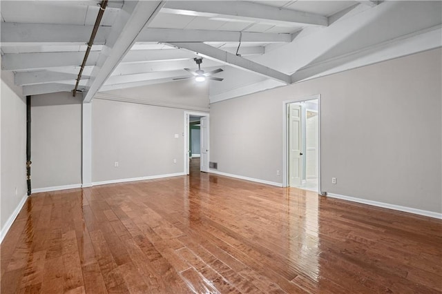 spare room with wood-type flooring, vaulted ceiling with beams, and ceiling fan