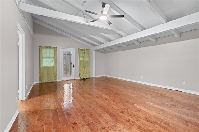 empty room with lofted ceiling with beams, ceiling fan, and hardwood / wood-style floors