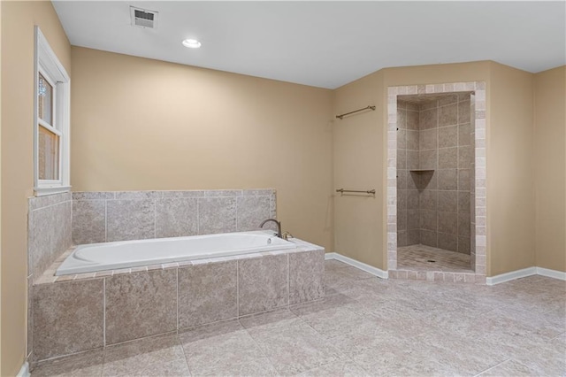 bathroom featuring shower with separate bathtub