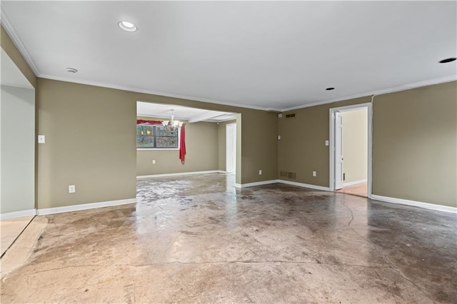 spare room featuring crown molding, concrete floors, and an inviting chandelier