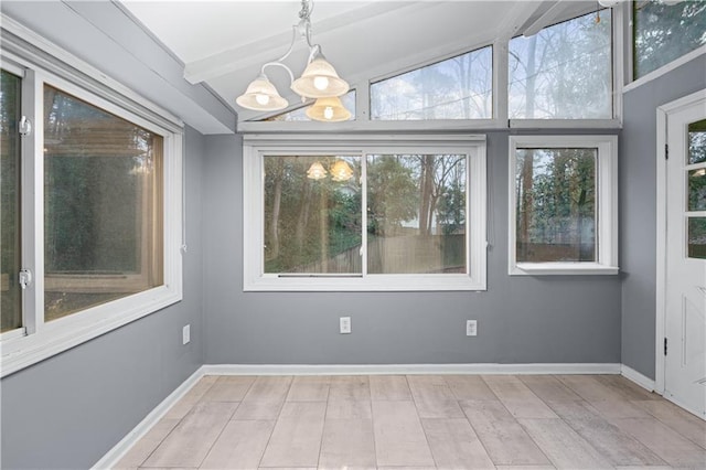 interior space with beamed ceiling and a chandelier