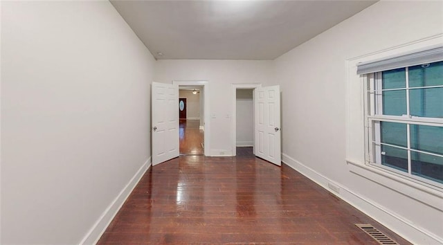 unfurnished bedroom with wood-type flooring and baseboards