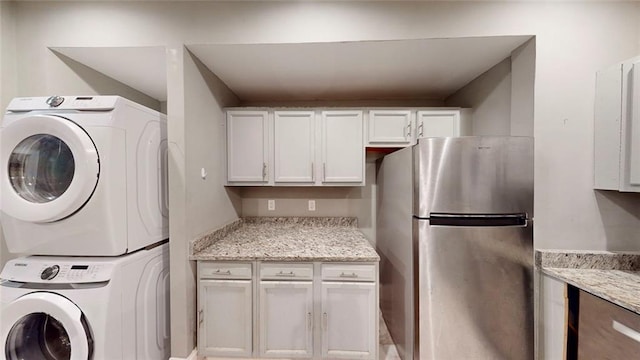 laundry room featuring stacked washing machine and dryer