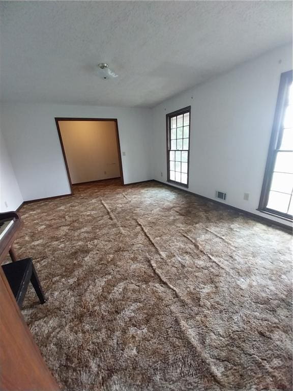 6005 Hendrix Rd, Cumming, GA 30040 - carpeted empty room with healthy amount of natural light and a textured ceiling