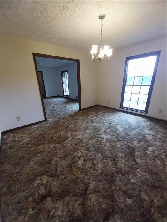 6005 Hendrix Rd, Cumming, GA 30040 - carpeted spare room featuring a chandelier and a textured ceiling