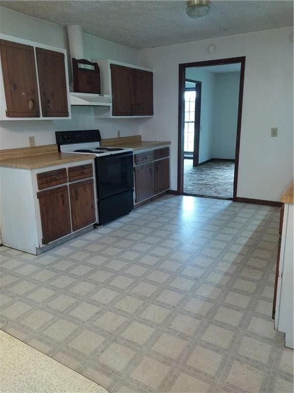 6005 Hendrix Rd, Cumming, GA 30040 - kitchen featuring electric range oven, under cabinet range hood, light floors, light countertops, and a textured ceiling
