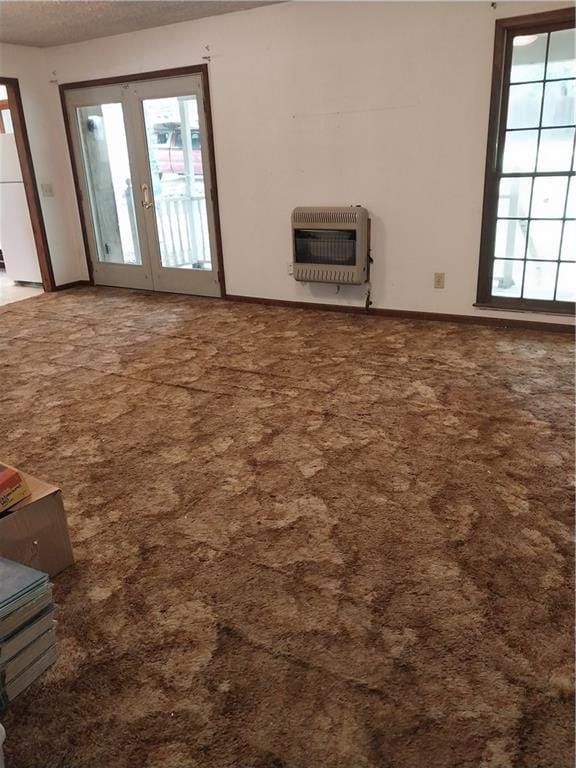 6005 Hendrix Rd, Cumming, GA 30040 - unfurnished living room featuring heating unit, carpet floors, plenty of natural light, and a textured ceiling
